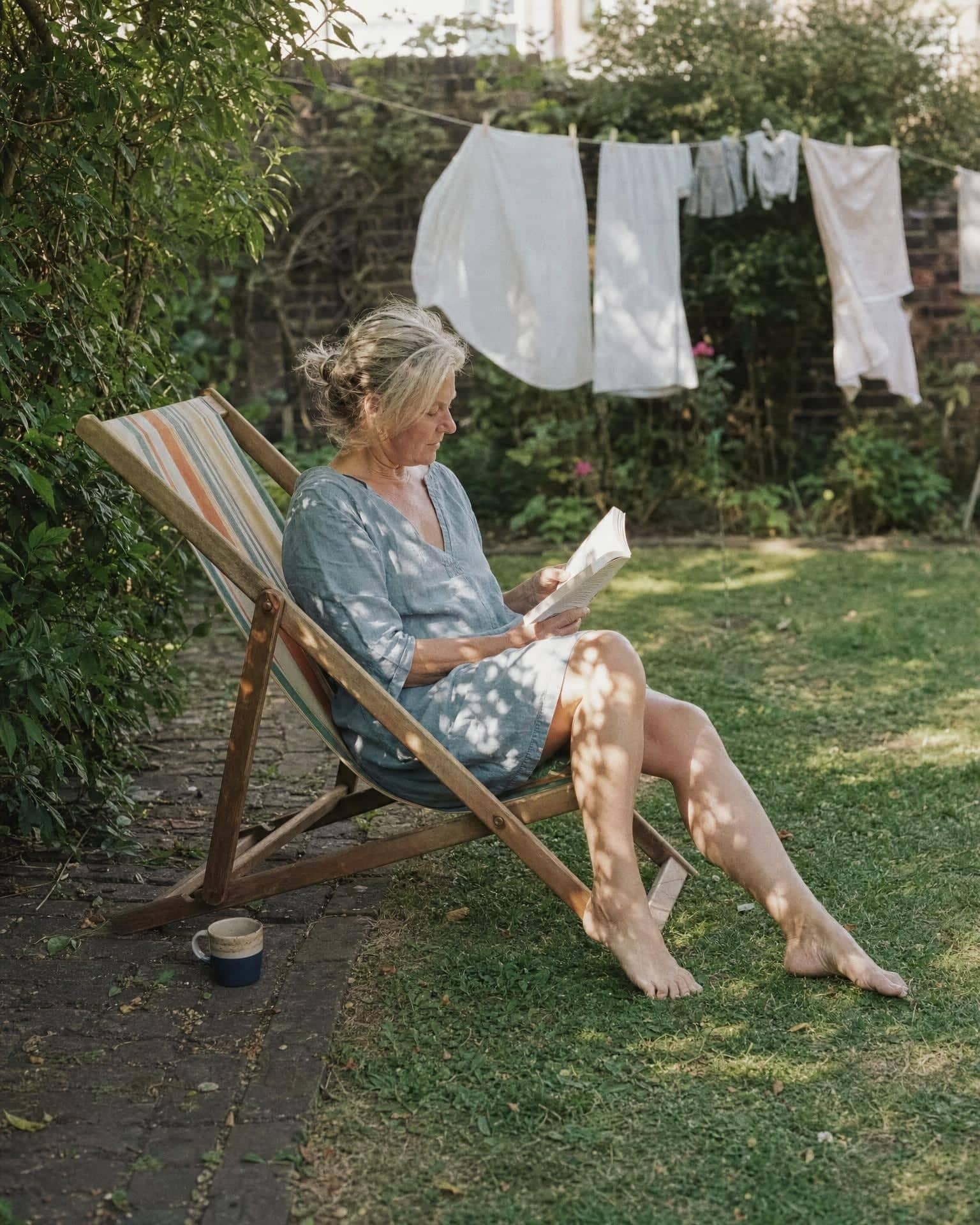 A woman reading in a deckchair in a London back garden
